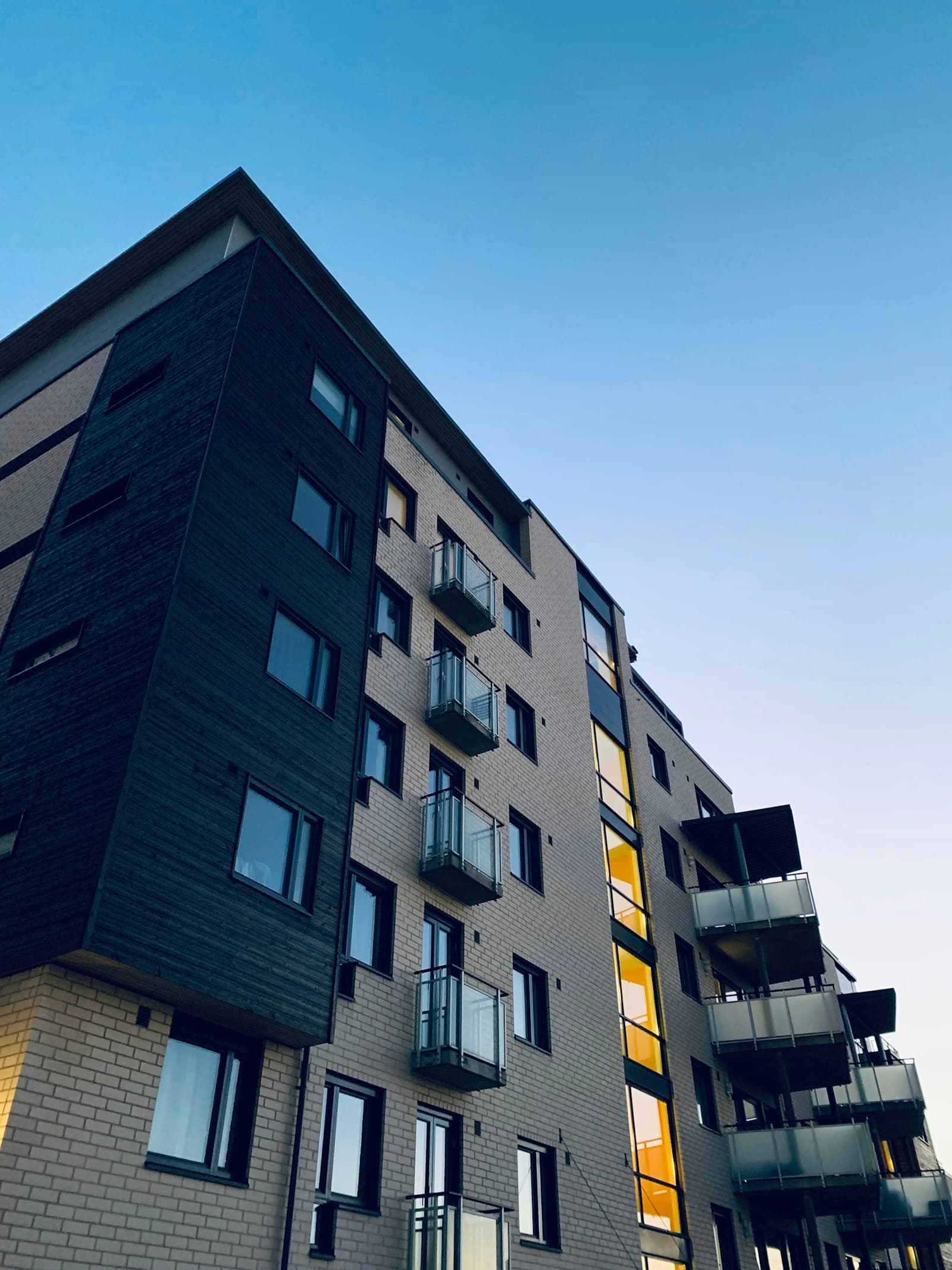 Exterior of a mid-rise apartment building, the kind of asset a real estate syndication is formed to acquire
